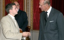 Colin Sanders is presented with his award and congratulated by the Duke of Edinburgh